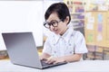 Little Girl Wearing Glasses And Using Laptop Royalty Free Stock Photo