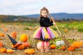 Little girl wearing halloween witch costume on pumpkin patch Royalty Free Stock Photo