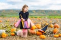 Little girl wearing halloween witch costume on pumpkin patch Royalty Free Stock Photo