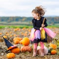 Little girl wearing halloween witch costume on pumpkin patch Royalty Free Stock Photo