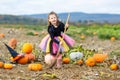 Little girl wearing halloween witch costume on pumpkin patch Royalty Free Stock Photo