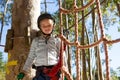 Little girl wearing helmet standing near rope fence Royalty Free Stock Photo