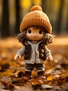 a little girl wearing a knitted hat standing in a pile of fallen leaves