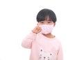 Little girl wearing a mask in front of white background Royalty Free Stock Photo