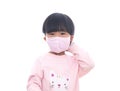 Little girl wearing a mask in front of white background Royalty Free Stock Photo