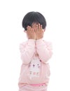 Little girl wearing mask in front of white background covers her face with hands Royalty Free Stock Photo