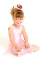 Little girl wearing pink ballet dress sitting