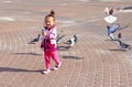 A little girl chasing pigeons Royalty Free Stock Photo