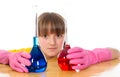Little girl wearing pink gloves with flasks for chemistry