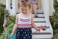 Little girl wearing red white and blue and holding a pinwheel to celebrate the Fourth of July Royalty Free Stock Photo