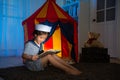 Little girl wearing sailor clothing playing game