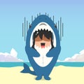 little girl wearing a shark costume character fright and got shocked isolated on a beach background. little girl wearing a shark Royalty Free Stock Photo