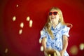 Little girl wearing sunglasses and eating popcorn Royalty Free Stock Photo