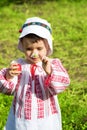 Little girl wearing a traditional Romanian blouse named ie and smelling a flower Royalty Free Stock Photo