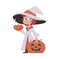 A little girl is wearing a witch costume and has a bright and colorful pumpkin in her hands. Halloween is a holiday that Royalty Free Stock Photo