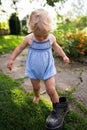 Little girl wears big grandfather`s shoe Royalty Free Stock Photo