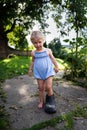 Little girl wears big grandfather`s shoe Royalty Free Stock Photo