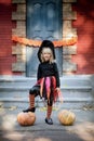 little girl in whitch costume celebrate Halloween outdoor and have fun