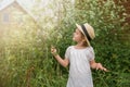 Little Girl in a white boho dress with in beautiful green thickets of grass. Royalty Free Stock Photo