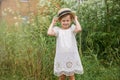 Little Girl in a white boho dress with in beautiful green thickets of grass. Royalty Free Stock Photo