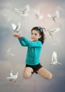 Little girl and white doves