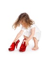 Little girl in white dress with big red shoes Royalty Free Stock Photo