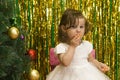 Little girl in white dress eat slice mandarin fruit Royalty Free Stock Photo