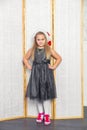 Little girl with white hair in a gray dress red Royalty Free Stock Photo