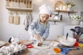 Little girl in a white shef hat cook the dough for cookies Royalty Free Stock Photo