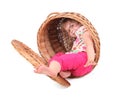 Little girl in wicker box