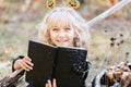 little girl in witch costume celebrate Halloween outdoor and have fun