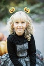 little girl in witch costume celebrate Halloween outdoor and have fun