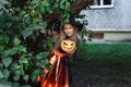 Little girl in witch costume on Halloween trick or treat in garden Royalty Free Stock Photo