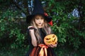 Little girl in witch costume on Halloween trick or treat in garden Royalty Free Stock Photo