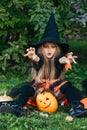Little girl in witch costume having fun on Halloween trick or treat Royalty Free Stock Photo