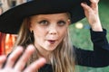 Little girl in witch costume having fun on Halloween trick or treat Royalty Free Stock Photo