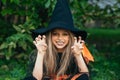 Little girl in witch costume having fun on Halloween trick or treat Royalty Free Stock Photo