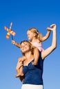 Little girl and woman with a pinwheel toy outdoors Royalty Free Stock Photo