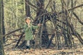 Little girl in the wood near hut Royalty Free Stock Photo