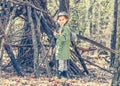 Little girl in the wood near the hut Royalty Free Stock Photo