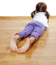 A little girl on a wooden floor Royalty Free Stock Photo