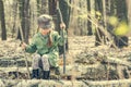 Little girl in the woods sitting on a stump Royalty Free Stock Photo