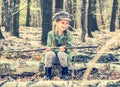 Little girl in the woods sitting on a stump Royalty Free Stock Photo