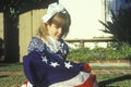 Little Girl Wrapped in American Flag, United States