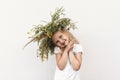 Little girl in a wreath of flowers on a white background. Royalty Free Stock Photo