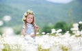 Little girl in a wreath of white daisies Royalty Free Stock Photo