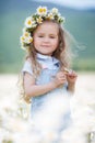 Little girl in a wreath of white daisies Royalty Free Stock Photo