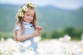 Little girl in a wreath of white daisies Royalty Free Stock Photo