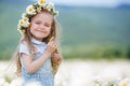 Little girl in a wreath of white daisies Royalty Free Stock Photo