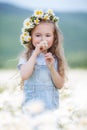 Little girl in a wreath of white daisies Royalty Free Stock Photo